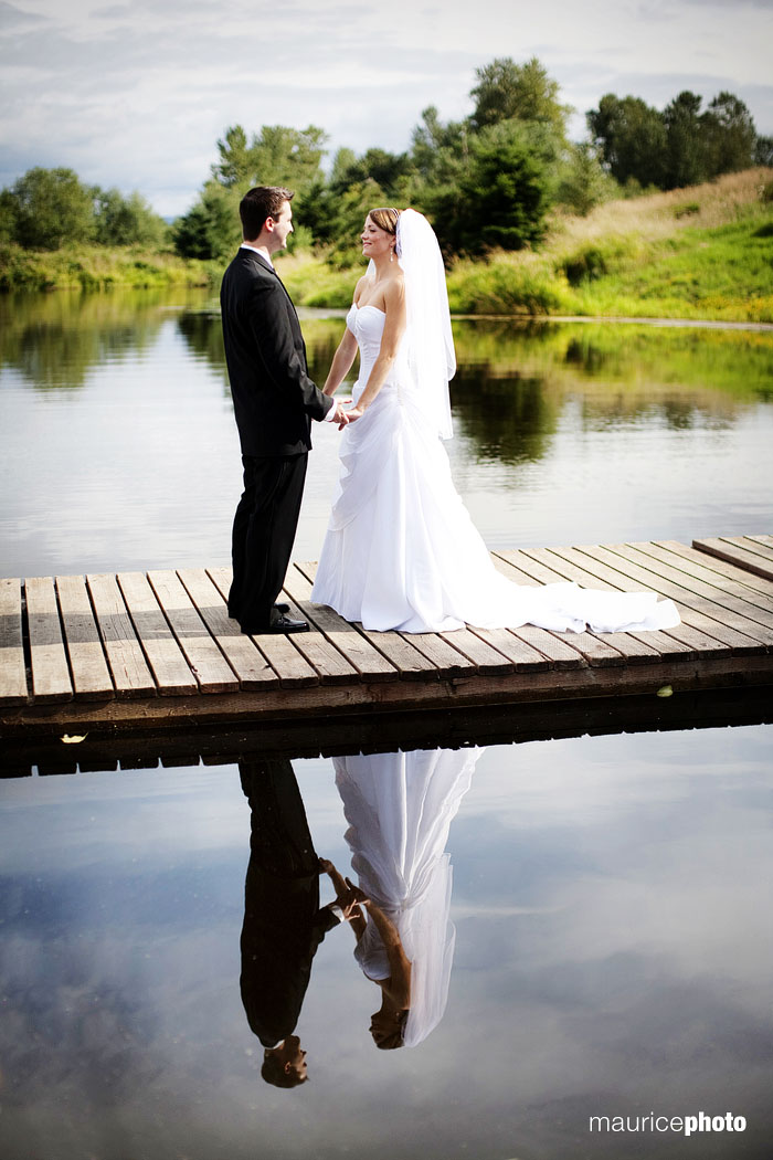 A portrait of a bride and groom on the dock at Lord Hill Farms