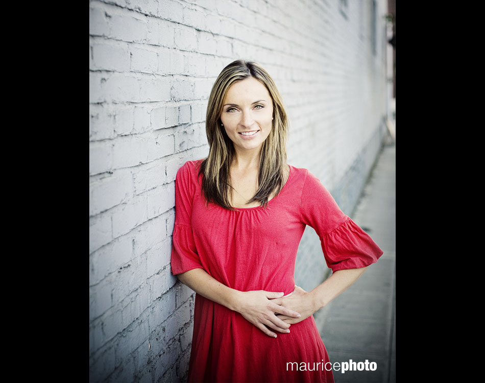 A picture from a fashion photo shoot against a blue brick wall