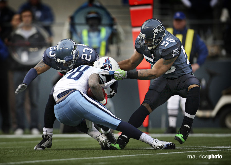 Chris Johnson is tackled by Seahawk defenders. 