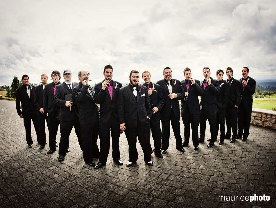 Groom and groomsmen posing with cigars.