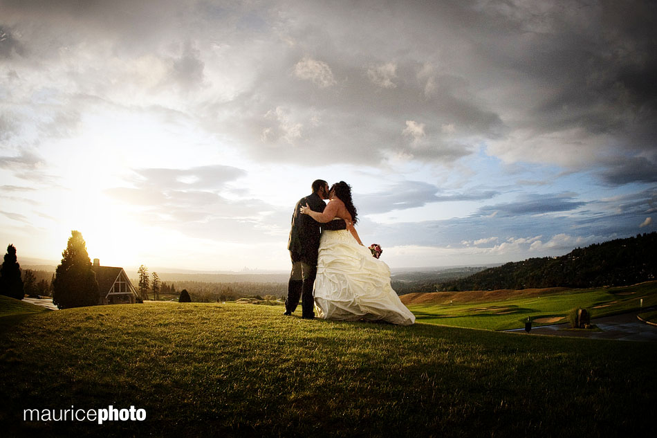 Groom kissing bride on the grass hill at Newcastle.
