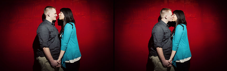 Photo of a couple kissing in front of the Experience Music Project in downtown Seattle. EMP engagement portraits.