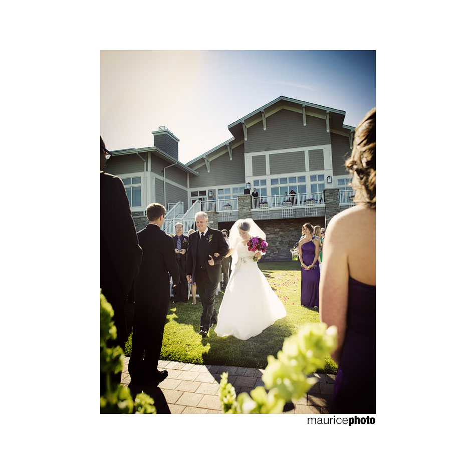 Bride and Father walking down aisle during outdoor wedding ceremony. 