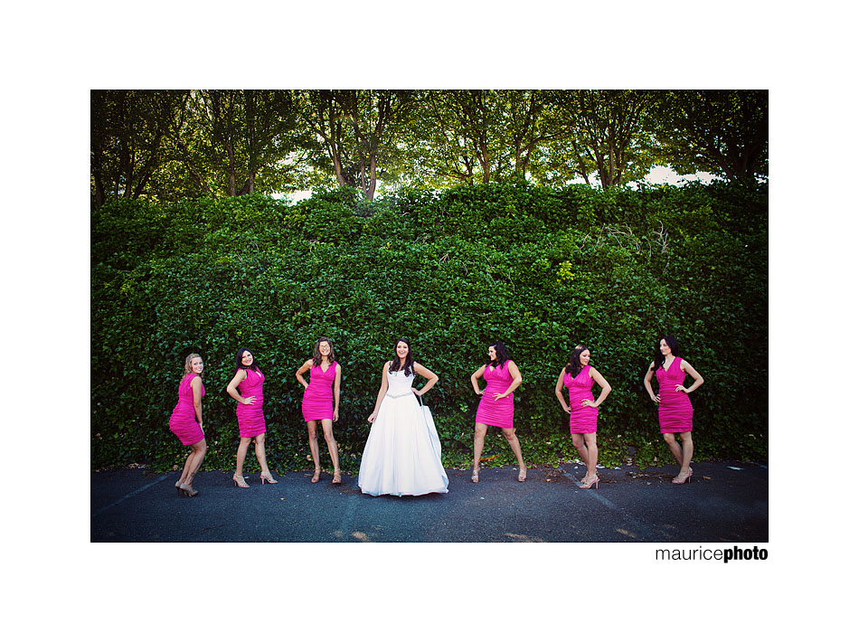 Bride and bridesmaids pose for pictures at a wedding. 
