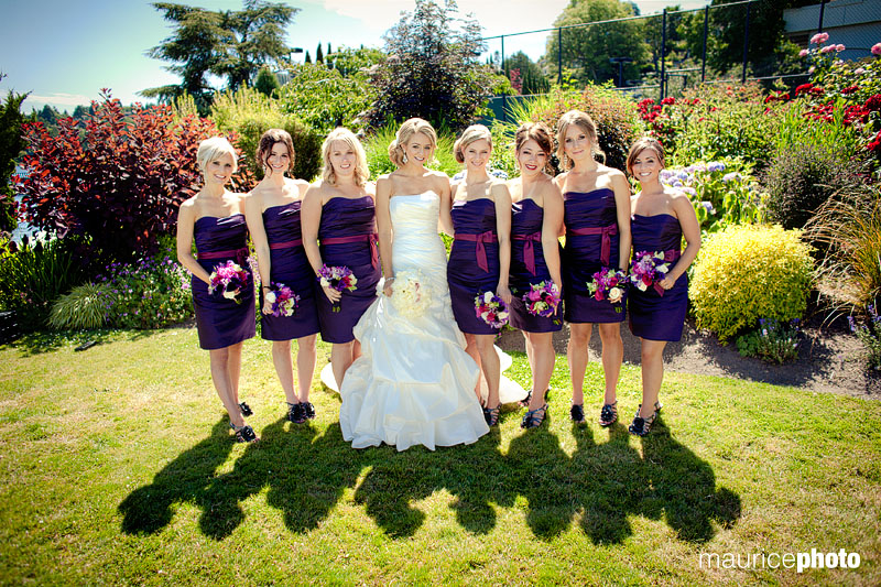 Bridesmaids pose with the bride for formal pictures