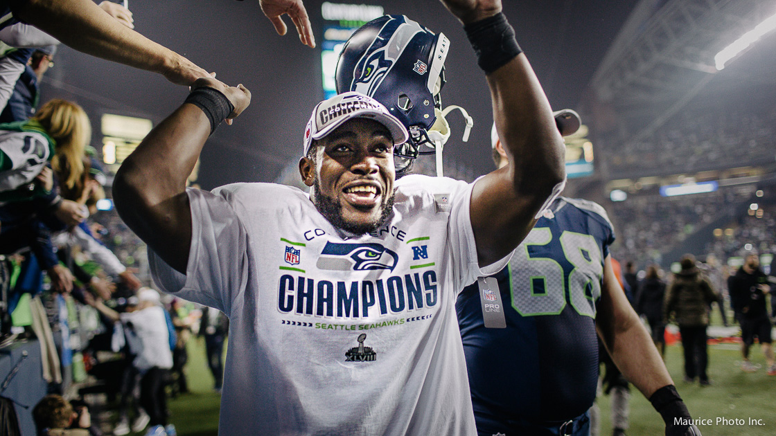 Seahawks Safety Kam Chancellor hi-fiving the crowd