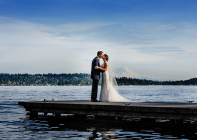 Bride and groom pose for pictures with a Mt. Rainier view.