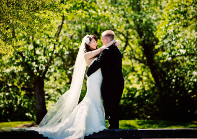 bride and groom pose for pictures at their wedding