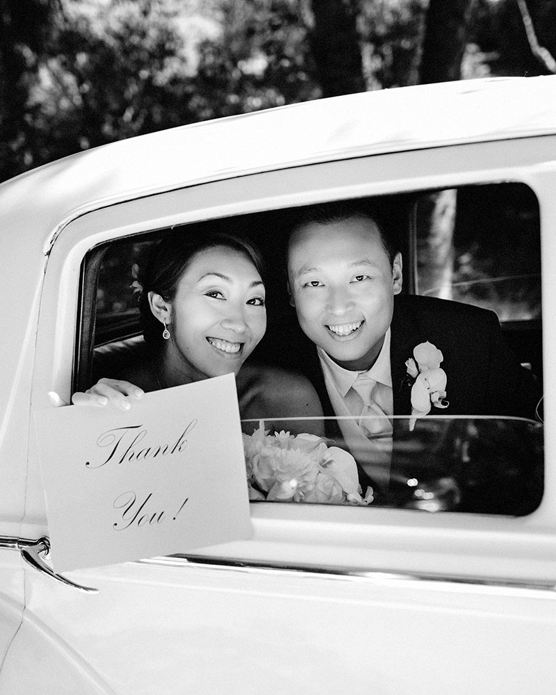 Bride and Groom with thank you sign
